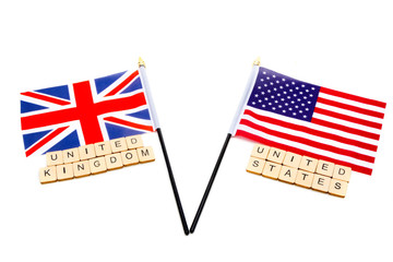 The flags of the United Kingdom and the United States isolated on a white background with a sign reading United Kingdom United States