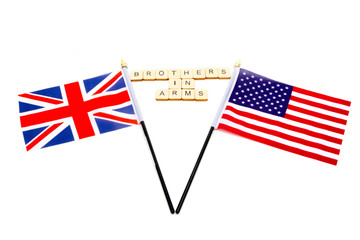 The flags of the United Kingdom and the United States isolated on a white background with a sign reading Brothers in Arms