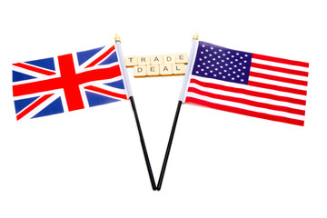 The flags of the United Kingdom and the United States isolated on a white background with a sign reading Trade Deal