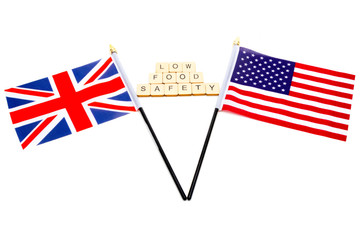 The flags of the United Kingdom and the United States isolated on a white background with a sign reading Low Food Safety