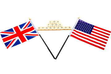 The flags of the United Kingdom and the United States isolated on a white background with a sign reading Low Food Standards