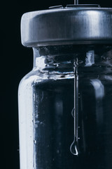 Medicine, Injection, vaccine and disposable syringe, drug concept. Sterile vial medical syringe needle. Macro close up. Glass medical ampoule vial for injection. Bottles ampule with aluminum cap.