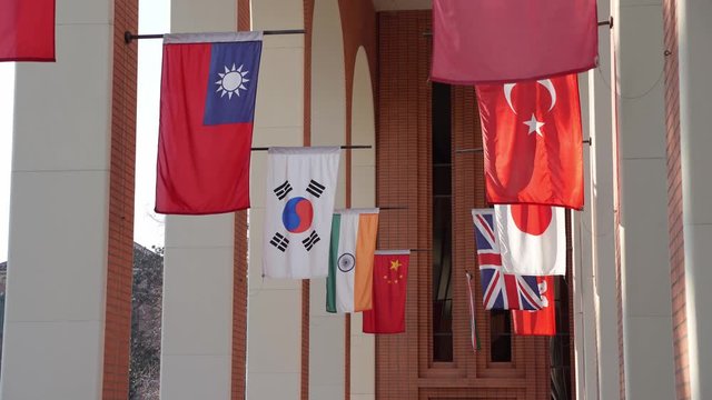 Afternoon sunny view of some international flags hangin in the VKC Library of USC