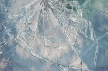 broken car windshield with sky reflection. close up