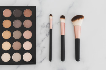 beauty industry and make-up products, eyeshadow palette with nudes and bronzy tones with brushes