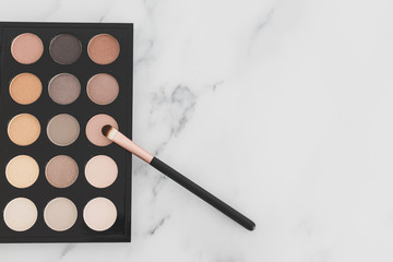beauty industry and make-up products, eyeshadow palettes with nudes and bronzy tones with brushes