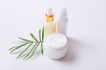 Fototapeta na wymiar Herbal dermatology cosmetic products and cream on white background