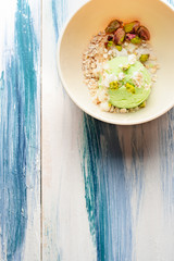 Pistachio ice cream with white chocolate on modern table. Healthy food. Vegan food