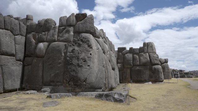 Huge massive stone blocks forming massive defensive citadel walls at famous Inca fortress ruins of Sacsayhuaman in Cusco region, Peru. Traditional Inca construction and architecture. 
