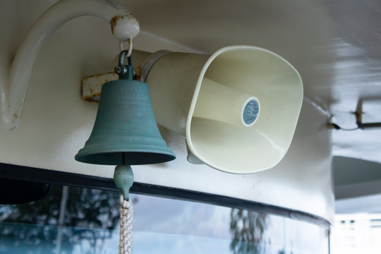 White megaphone hanging on a wood wall