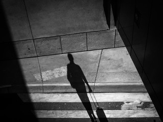 Upside Down Image Of Woman Shadow On Footpath