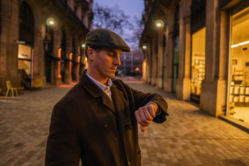 Old Fashion Man from the 1920s england walking along an old street of a historic city. He is...