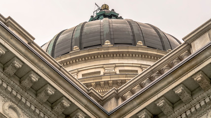 Panorama Utah State Capitol building and dome in Salt Lake City against bright cloudy sky