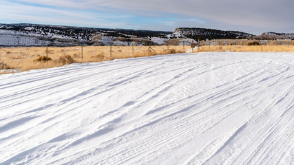 Panorama Close up of fresh white snow covering an expansive terrain during winter season