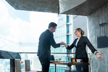 Partners man and women  joining hands to success together. Business Team stack of hands for star up project and sign agreement contract, city background. Team work and Business Concept