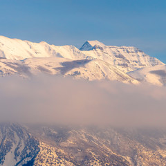 Square Scenic winter view of majestic Mount Timpanogos with snow against blue sky