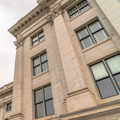 Fototapeta na wymiar Square Utah State Capitol Building with decorative mouldings viewed against cloudy sky