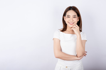 Beautiful young asian stand and pose with big smile happy beaming face in white background.