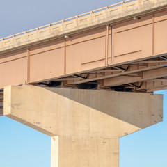 Square frame View beneath a stringer bridge with massive abutment that supports the deck