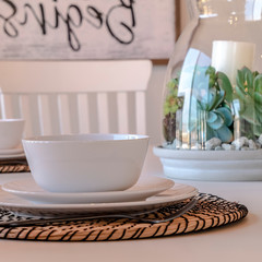 Photo Square frame Dining room table setting of home with tableware placemat and centerpiece