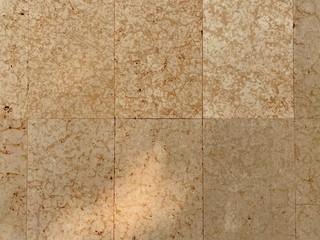 Brown granite wall background with sunlight