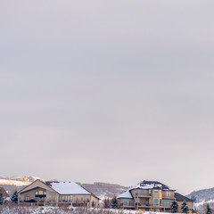 Square Tranquil residential area on a hill top covered with fresh snow on a winter day