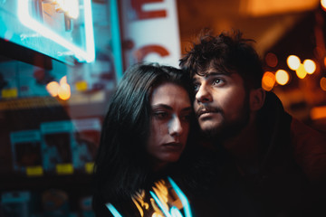 Fototapeta premium Valentine's Day content, two sweet couple hugging and street themed in lighted background. Valentine's day concept pose.