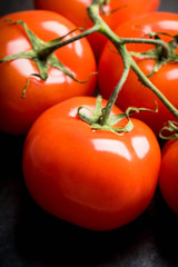 Freshly harvested tomatoes on the rustic background. Selective focus. Shallow depth of field.