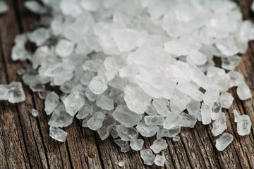 Sea salt on the rustic background. Selective focus. Shallow depth of field.