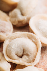Raw dumplings in flour on the table. Russian national food. Selective focus.