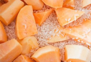 Ingredients for making pumpkin porridge.  Sliced ??pumpkin.  White rice.  Close-up