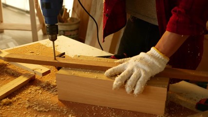 Woodwork and furniture making concept. Stylish craftsman working in his carpentry workshop
