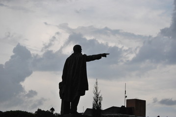 Statue pointing against sky