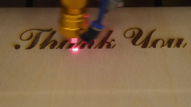 Creating engraving on wood with laser beam