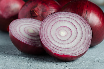 Red onion. Close-up on a gray background.