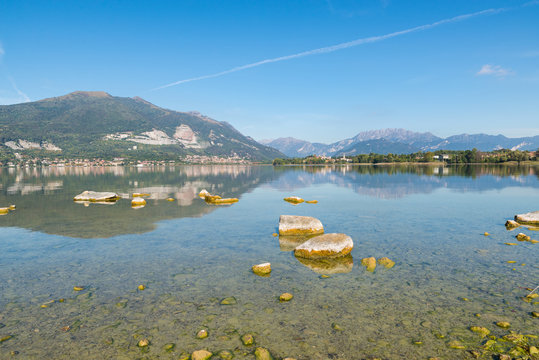 Beautiful Italian lake. Lake Pusiano with in the background the towns of Pusiano (to the left) and Bosisio Parini. It is one of the Brianza lakes that lie between the cities of Como and Lecco 