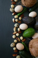 Ketogenic Diet.Lchf. Avocado,coconut,  eggs and nuts on a black slate background.Keto products. .Vegetables and nuts for low carb diet.