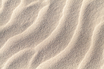 Fototapeta na wymiar Sand ripples, close-up photo. Abstract natural background texture