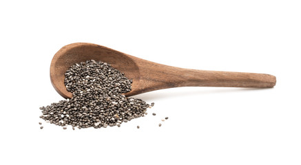 Brown wooden overturned spoon with chia seeds seen from the side and isolated on white background