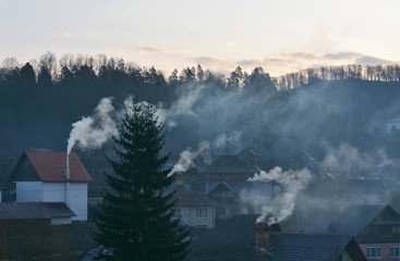 smoke from the chimneys of the houses in the morning
