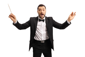 Man in a suit conducting with a baton