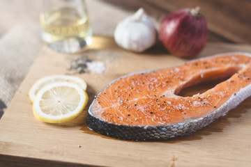 Fresh uncooked salmon on a wooden cutting board. Concept of diet menu and cooking ingredient