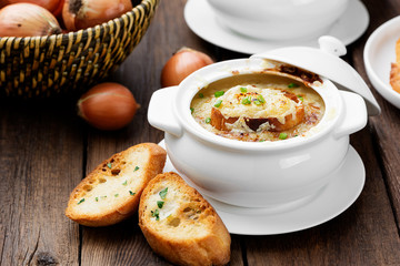 Homemade French onion soup with toasted baguette and melted cheese.