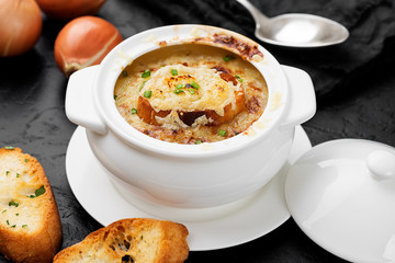 Homemade French onion soup with toasted baguette and melted cheese.
