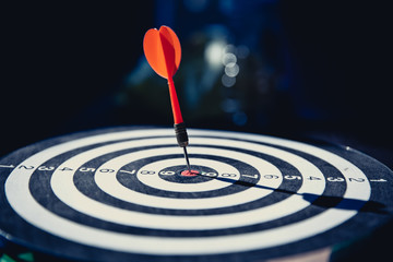 Close up red color arrow in the center of Bullseye or bull's-eye for business targeting and good...