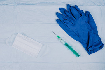 Protection and prevention against viruses. Gloves, syringe and mask
