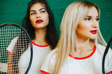 Girls on the tennis court. Stylish ladies in a sports clothes
