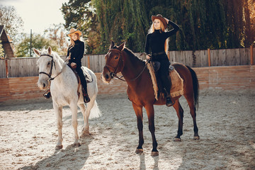 Girls with a horse. Women in a ranch. Blonde in a black sweater
