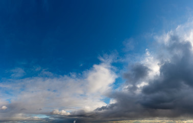 Fantastic clouds against blue sky, panorama