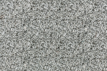 mottled gray granite texture with black splashes. stone surface pattern background